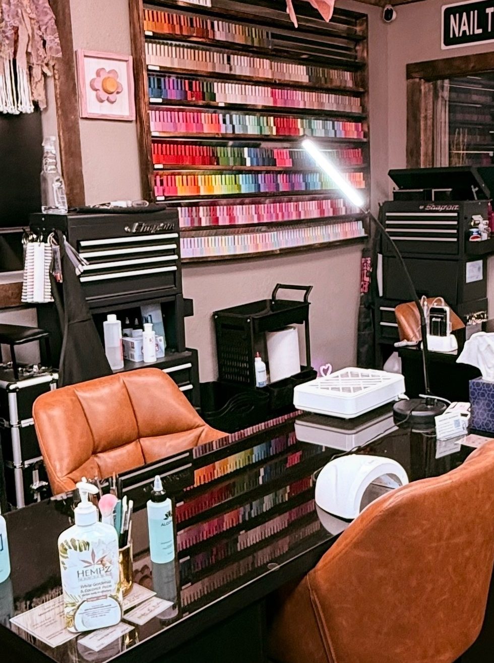 The main floor at GoodLife Nailz: the polish wall and a station